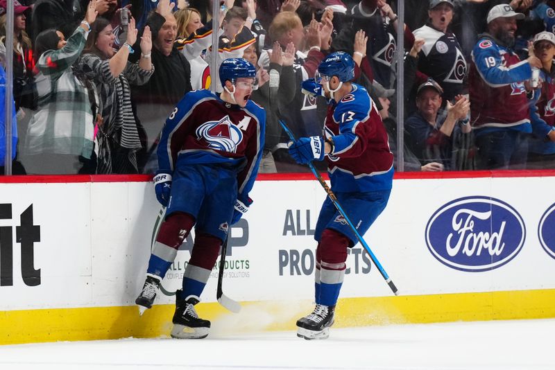 Nov 22, 2023; Denver, Colorado, USA; Colorado Avalanche defenseman Cale Makar (8) celebrates his goal with right wing Valeri Nichushkin (13) against the Vancouver Canucks at Ball Arena. Mandatory Credit: Ron Chenoy-USA TODAY Sports