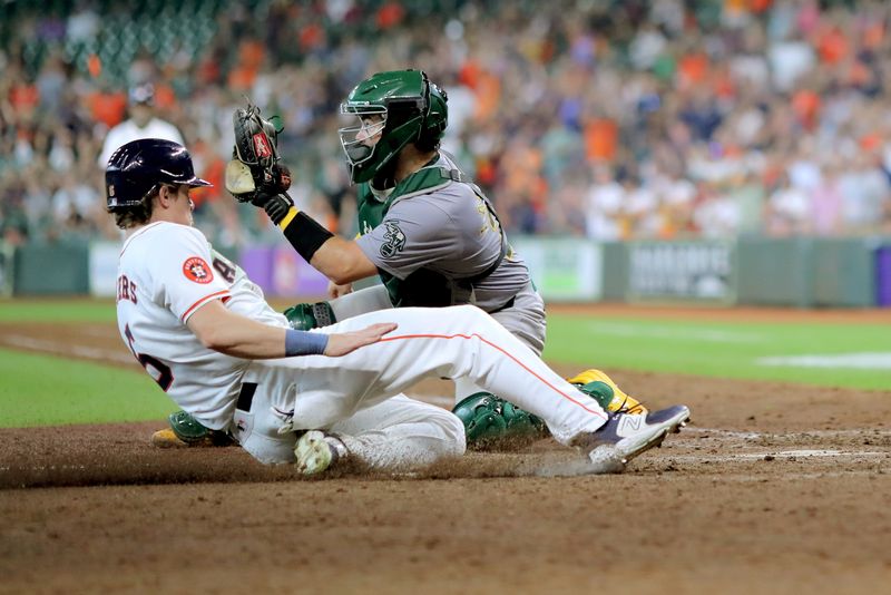 Sep 12, 2024; Houston, Texas, USA; Houston Astros center fielder Jake Meyers (6) slides into home plate to score a run against the Oakland Athletics during the eighth inning at Minute Maid Park. Mandatory Credit: Erik Williams-Imagn Images