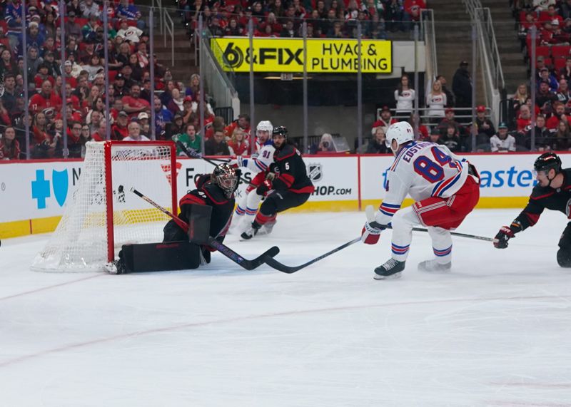 Nov 27, 2024; Raleigh, North Carolina, USA;  New York Rangers center Adam Edstrom (84) scores a goal past Carolina Hurricanes goaltender Spencer Martin (41) during the second period at Lenovo Center. Mandatory Credit: James Guillory-Imagn Images