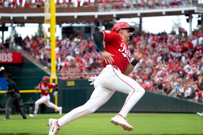 Jul 12, 2025; Cincinnati, Ohio, USA;  Cincinnati Reds first baseman Spencer Steer (7) scores on a triple hit by right fielder Will Benson (not shown) in the ninth inning against the Colorado Rockies at Great American Ball Park. Mandatory Credit: Albert Cesare/The Cincinnati Enquirer-Imagn Images