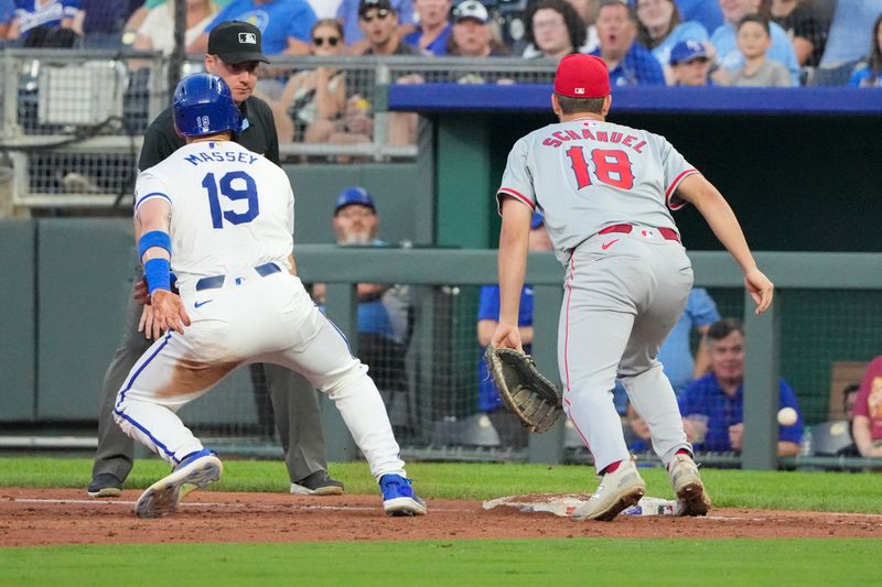 Aug 19, 2024; Kansas City, Missouri, USA; Los Angeles Angels first baseman Nolan Schanuel (18) misses a throw to first base allowing Kansas City Royals second baseman Michael Massey (19) to reach second base in the third inning at Kauffman Stadium. Mandatory Credit: Denny Medley-USA TODAY Sports