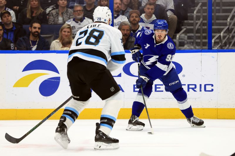 Jan 26, 2026; Tampa, Florida, USA; Tampa Bay Lightning center Gage Goncalves (93) skates with the puck as Utah Mammoth defenseman Ian Cole (28) defends during the first period at Benchmark International Arena. Mandatory Credit: Kim Klement Neitzel-Imagn Images