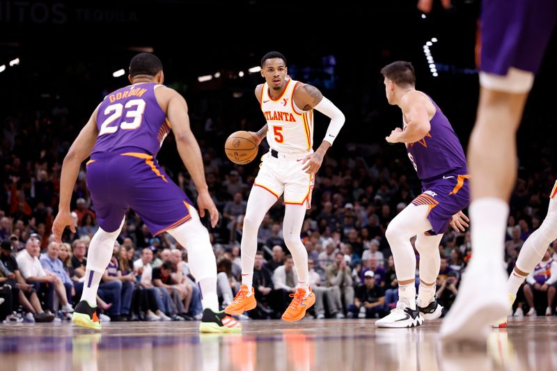 PHOENIX, ARIZONA - MARCH 21: Dejounte Murray #5 of the Atlanta Hawks controls the ball during the first half against the Phoenix Suns at Footprint Center on March 21, 2024 in Phoenix, Arizona. NOTE TO USER: User expressly acknowledges and agrees that, by downloading and or using this photograph, User is consenting to the terms and conditions of the Getty Images License Agreement.  (Photo by Chris Coduto/Getty Images)