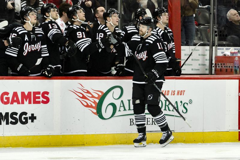 Apr 7, 2024; Newark, New Jersey, USA; New Jersey Devils center Chris Tierney (11) celebrates with teammates after scoring a goal against the Nashville Predators during the third period at Prudential Center. Mandatory Credit: John Jones-USA TODAY Sports