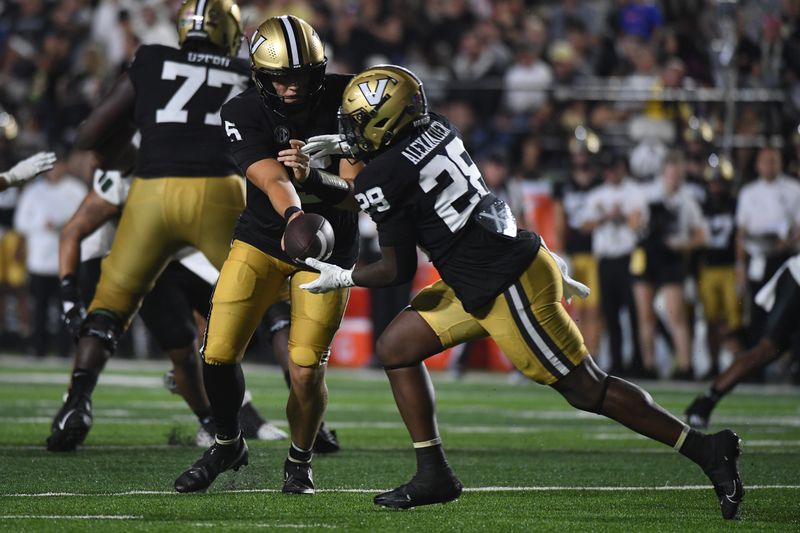 Aug 26, 2023; Nashville, Tennessee, USA; Vanderbilt Commodores quarterback AJ Swann (5) hands the ball off to running back Sedrick Alexander (28) during the first half against the Hawaii Warriors at FirstBank Stadium. Mandatory Credit: Christopher Hanewinckel-USA TODAY Sports