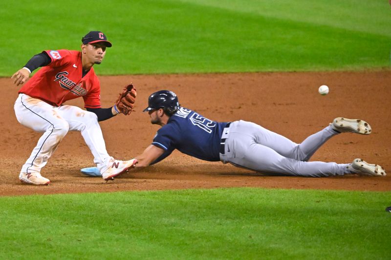 Sep 2, 2023; Cleveland, Ohio, USA; Tampa Bay Rays right fielder Josh Lowe (15) steals second base against Cleveland Guardians second baseman Andres Gimenez (0) in the eleventh inning at Progressive Field. Mandatory Credit: David Richard-USA TODAY Sports