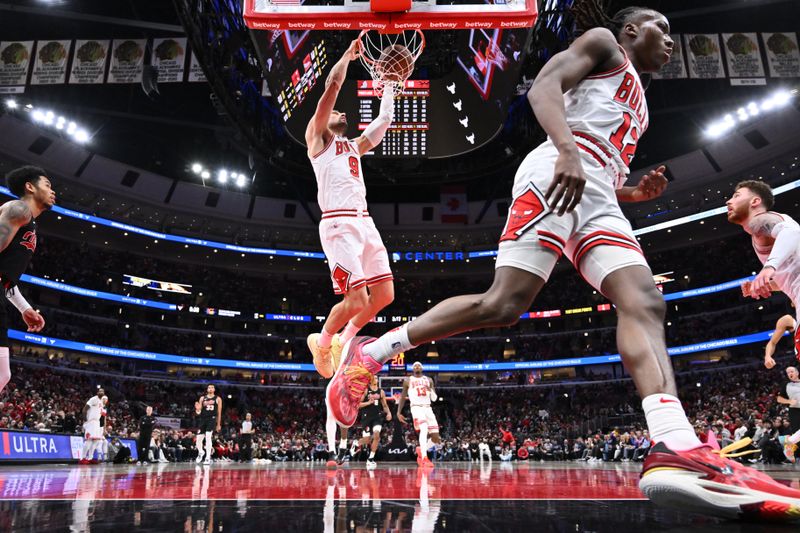 CHICAGO, ILLINOIS - MARCH 18:  Nikola Vucevic #9 of the Chicago Bulls finishes off a fast break with a dunk in the second half against the Portland Trail Blazers on March 18, 2024 at United Center in Chicago, Illinois. Chicago defeated Portland 110-107.   NOTE TO USER: User expressly acknowledges and agrees that, by downloading and or using this photograph, User is consenting to the terms and conditions of the Getty Images License Agreement.  (Photo by Jamie Sabau/Getty Images)