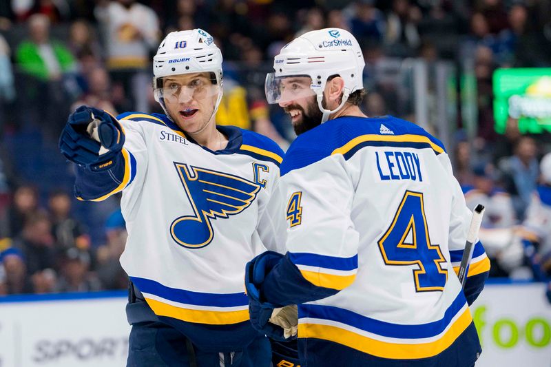 Jan 24, 2024; Vancouver, British Columbia, CAN; St. Louis Blues forward Brayden Schenn (10) and defenseman Nick Leddy (4) celebrate Schenn   s game winning goal against the Vancouver Canucks in overtime at Rogers Arena. Blues 4-3 in overtime. Mandatory Credit: Bob Frid-USA TODAY Sports