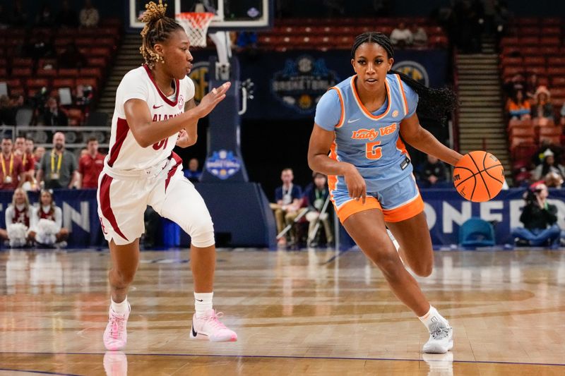 Mar 8, 2024; Greensville, SC, USA; Tennessee Lady Vols guard Kaiya Wynn (5) drives to the basket defended by Alabama Crimson Tide forward Naomi Jones (31) during the second half at Bon Secours Wellness Arena. Mandatory Credit: Jim Dedmon-USA TODAY Sports