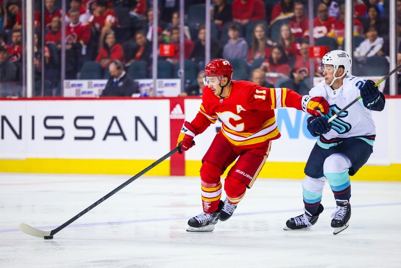 Oct 3, 2022; Calgary, Alberta, CAN; Calgary Flames center Mikael Backlund (11) controls the puck against the Seattle Kraken during the third period at Scotiabank Saddledome. Mandatory Credit: Sergei Belski-USA TODAY Sports