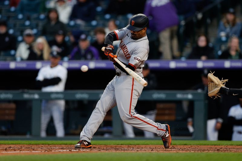 May 7, 2024; Denver, Colorado, USA; San Francisco Giants first baseman LaMonte Wade Jr. (31) hits a two RBI single in the fourth inning against the Colorado Rockies at Coors Field. Mandatory Credit: Isaiah J. Downing-USA TODAY Sports