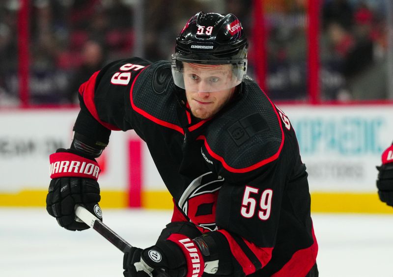 Mar 24, 2024; Raleigh, North Carolina, USA;  Carolina Hurricanes left wing Jake Guentzel (59) skates against the Toronto Maple Leafs during the first period at PNC Arena. Mandatory Credit: James Guillory-USA TODAY Sports