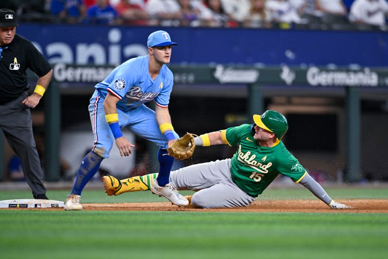 Sep 1, 2024; Arlington, Texas, USA; Oakland Athletics left fielder Seth Brown (15) slides past Texas Rangers third baseman Josh Jung (6) for a triple in the tenth inning at Globe Life Field. Mandatory Credit: Jerome Miron-USA TODAY Sports