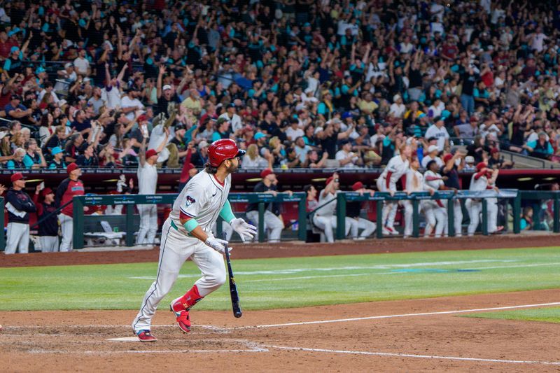 Apr 26, 2025; Phoenix, Arizona, USA;  Arizona Diamondbacks infielder Eugenio Suarez (28) reacts after hitting his fourth home run of the game against the Atlanta Braves during the ninth inning at Chase Field. Mandatory Credit: Allan Henry-Imagn Images