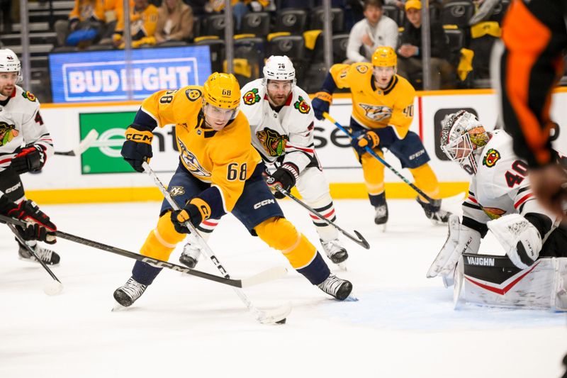 Jan 16, 2025; Nashville, Tennessee, USA;  Chicago Blackhawks goaltender Arvid Soderblom (40) blocks the shot of Nashville Predators left wing Zachary L'Heureux (68) during the first period at Bridgestone Arena. Mandatory Credit: Steve Roberts-Imagn Images