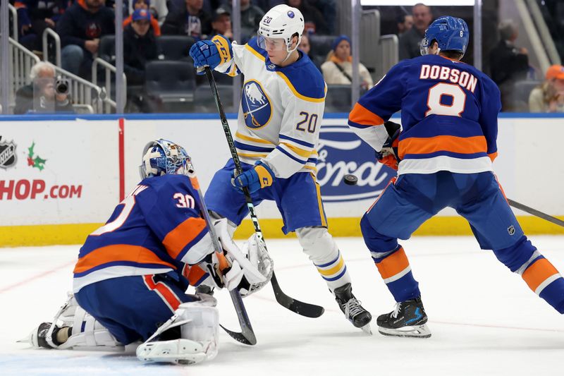 Nov 30, 2024; Elmont, New York, USA; New York Islanders goaltender Ilya Sorokin (30) makes a save in front of Buffalo Sabres center Jiri Kulich (20) and Islanders defenseman Noah Dobson (8) during the third period at UBS Arena. Mandatory Credit: Brad Penner-Imagn Images