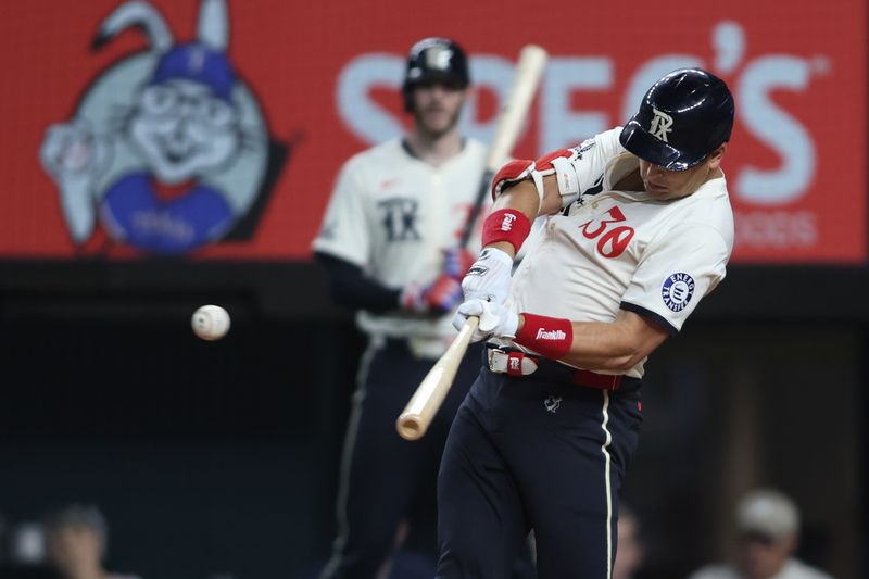 Sep 20, 2024; Arlington, Texas, USA; Texas Rangers first baseman Nathaniel Lowe (30) hits a two-RBI single in the fourth inning against the Seattle Mariners at Globe Life Field. Mandatory Credit: Tim Heitman-Imagn Images