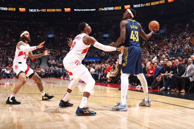 TORONTO, CANADA - APRIL 9:  RJ Barrett #9 of the Toronto Raptors plays defense during the game  against Pascal Siakam #43 of the Indiana Pacers on April 9, 2024 at the Scotiabank Arena in Toronto, Ontario, Canada.  NOTE TO USER: User expressly acknowledges and agrees that, by downloading and or using this Photograph, user is consenting to the terms and conditions of the Getty Images License Agreement.  Mandatory Copyright Notice: Copyright 2024 NBAE (Photo by Vaughn Ridley/NBAE via Getty Images)