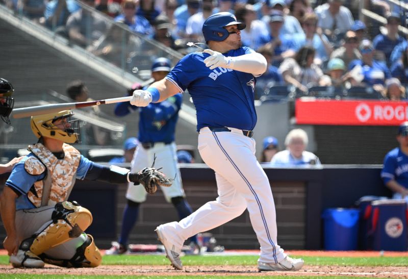 May 19, 2024; Toronto, Ontario, CAN; Toronto Blue Jays designated hitter Daniel Vogelbach (20) hits a single against the Tampa Bay Rays in the sixth inning at Rogers Centre. Mandatory Credit: Dan Hamilton-USA TODAY Sports