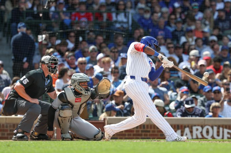 May 17, 2025; Chicago, Illinois, USA; Chicago Cubs catcher Vidal Brujan (17) hits an RBI-ground rule double against the Chicago White Sox during the fifth inning at Wrigley Field. Mandatory Credit: Kamil Krzaczynski-Imagn Images