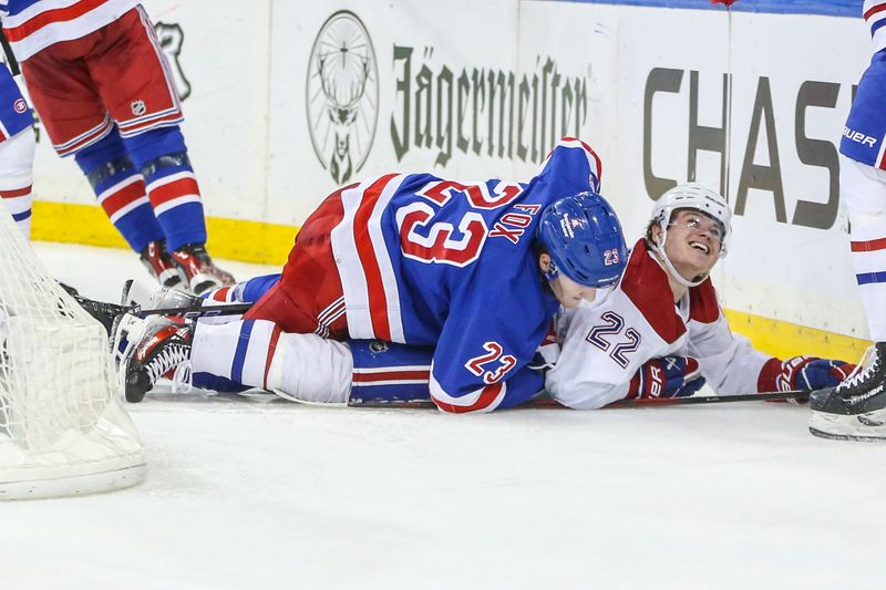 Feb 15, 2024; New York, New York, USA; New York Rangers defenseman Adam Fox (23) falls on Montreal Canadiens right wing Cole Caufield (22) who celebrates after scoring a goal in the third period at Madison Square Garden. Mandatory Credit: Wendell Cruz-USA TODAY Sports