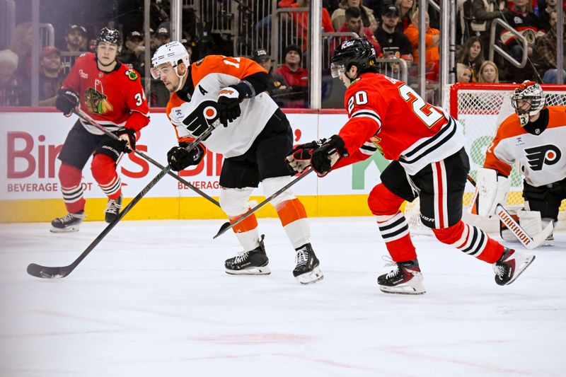 Dec 23, 2025; Chicago, Illinois, USA;  Philadelphia Flyers right wing Travis Konecny (11) moves the puck against Chicago Blackhawks center Ryan Greene (20) during the first period at United Center. Mandatory Credit: Matt Marton-Imagn Images