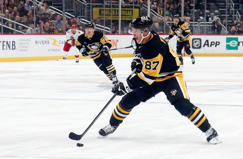 Oct 18, 2024; Pittsburgh, Pennsylvania, USA;  Pittsburgh Penguins center Sidney Crosby (87) skates with the puck against the Carolina Hurricanes during the first period at PPG Paints Arena. Mandatory Credit: Charles LeClaire-Imagn Images