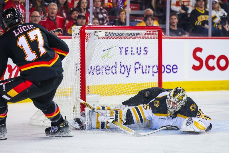 Feb 28, 2023; Calgary, Alberta, CAN; Boston Bruins goaltender Linus Ullmark (35) makes a save against Calgary Flames left wing Milan Lucic (17) during the second period at Scotiabank Saddledome. Mandatory Credit: Sergei Belski-USA TODAY Sports