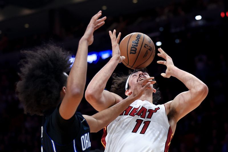 MIAMI, FLORIDA - OCTOBER 23: Jaime Jaquez Jr. #11 of the Miami Heat drives to the net against Anthony Black #0 of the Orlando Magic during the second half at Kaseya Center on October 23, 2024 in Miami, Florida. NOTE TO USER: User expressly acknowledges and agrees that, by downloading and or using this photograph, User is consenting to the terms and conditions of the Getty Images License Agreement. (Photo by Carmen Mandato/Getty Images)