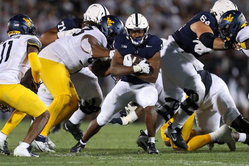 Sep 2, 2023; University Park, Pennsylvania, USA; Penn State Nittany Lions running back Nicholas Singleton (10) runs the ball against the West Virginia Mountaineers during the fourth quarter at Beaver Stadium. Penn State won 38-15. Mandatory Credit: Matthew O'Haren-USA TODAY Sports