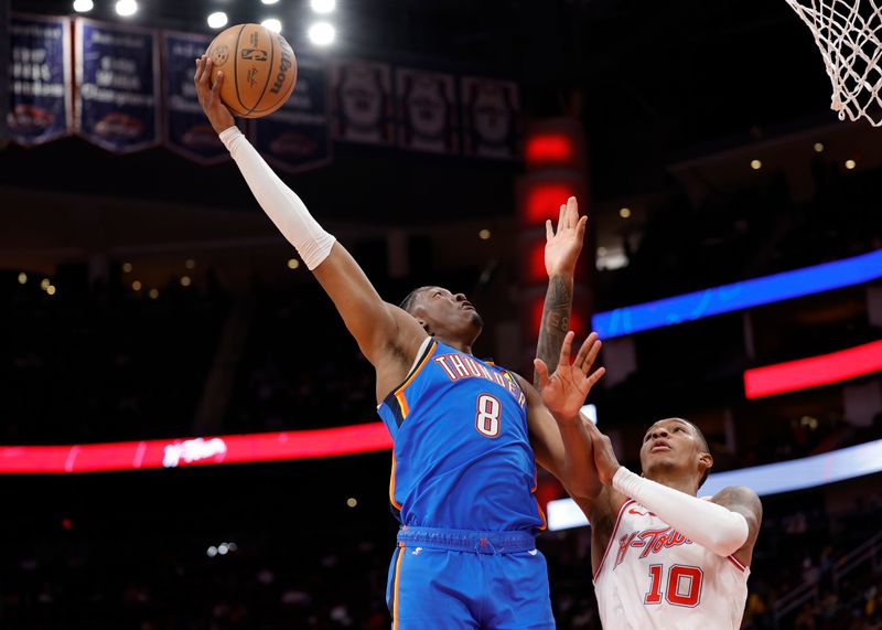 HOUSTON, TEXAS - DECEMBER 06: Jalen Williams #8 of the Oklahoma City Thunder drives against Jabari Smith Jr. #10 of the Houston Rockets during the first half at Toyota Center on December 06, 2023 in Houston, Texas. (Photo by Carmen Mandato/Getty Images)