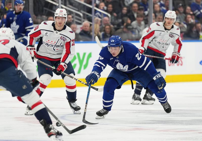 Dec 6, 2024; Toronto, Ontario, CAN; Toronto Maple Leafs right wing Pontus Holmberg (29) battles for the puck against the Washington Capitals during  the third period at Scotiabank Arena. Mandatory Credit: Nick Turchiaro-Imagn Images