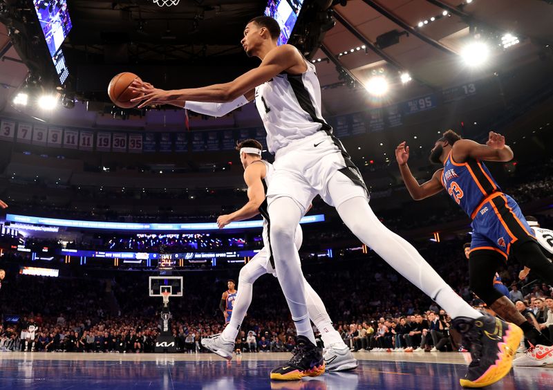 NEW YORK, NEW YORK - NOVEMBER 08:  Victor Wembanyama #1 of the San Antonio Spurs grabs the rebound in the first half against the New York Knicks at Madison Square Garden on November 08, 2023 in New York City. NOTE TO USER: User expressly acknowledges and agrees that, by downloading and or using this photograph, User is consenting to the terms and conditions of the Getty Images License Agreement. (Photo by Elsa/Getty Images)