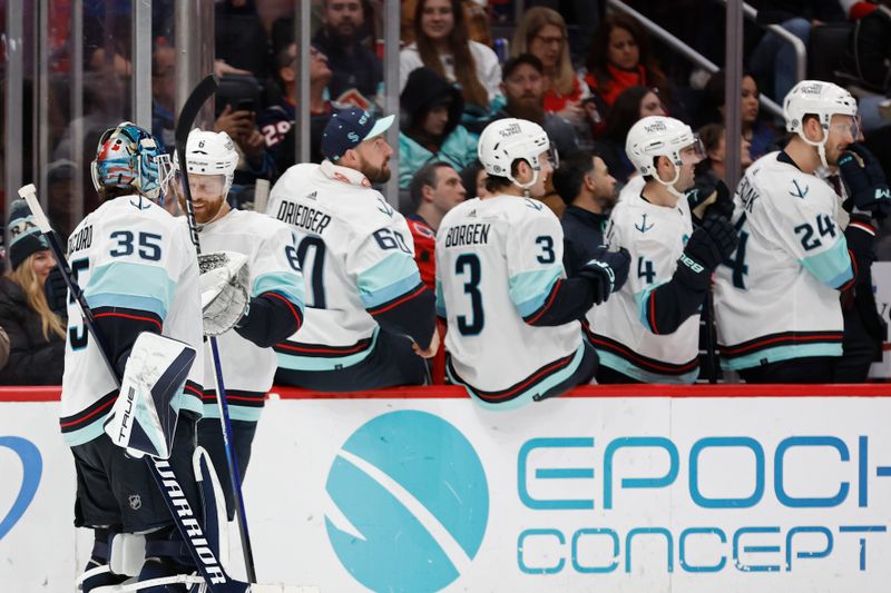 Jan 11, 2024; Washington, District of Columbia, USA; Seattle Kraken defenseman Adam Larsson (6) celebrates with Kraken goaltender Joey Daccord (35) after scoring a goal against the Washington Capitals in the third period at Capital One Arena. Mandatory Credit: Geoff Burke-USA TODAY Sports