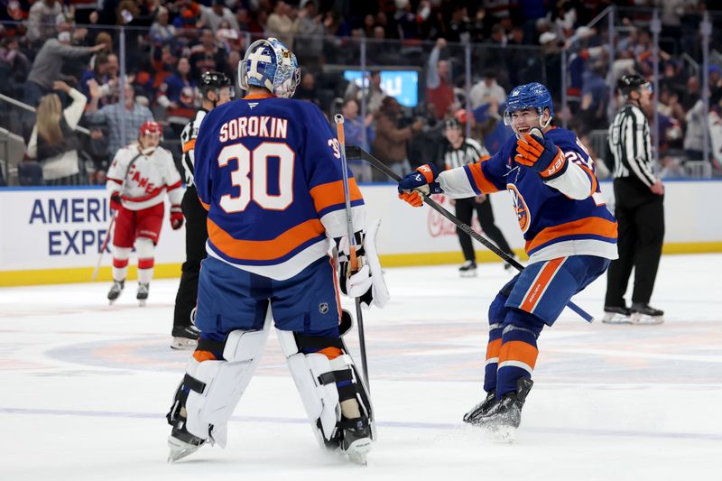 Jan 25, 2025; Elmont, New York, USA; New York Islanders defenseman Alexander Romanov (28) celebrates with goaltender Ilya Sorokin (30) after defeating the Carolina Hurricanes in overtime at UBS Arena. Mandatory Credit: Brad Penner-Imagn Images