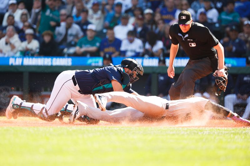 Sep 19, 2024; Seattle, Washington, USA; Seattle Mariners catcher Cal Raleigh (29) tags out New York Yankees left fielder Jasson Dominguez (89) during the second inning at T-Mobile Park. Mandatory Credit: Joe Nicholson-Imagn Images