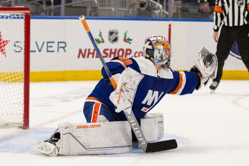 Nov 25, 2023; Elmont, New York, USA; New York Islanders goaltender Ilya Sorokin (30) makes a glove save against the Philadelphia Flyers during the overtime shootout at UBS Arena. Mandatory Credit: Thomas Salus-USA TODAY Sports