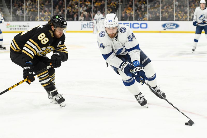 Feb 13, 2024; Boston, Massachusetts, USA; Tampa Bay Lightning center Tyler Motte (64) controls the puck while Boston Bruins right wing David Pastrnak (88) defends during the second period at TD Garden. Mandatory Credit: Bob DeChiara-USA TODAY Sports