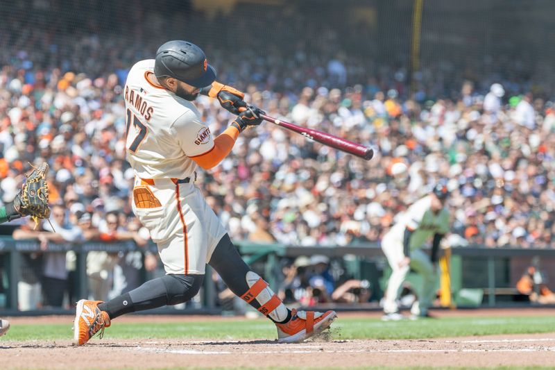 May 18, 2025; San Francisco, California, USA; San Francisco Giants outfielder Heliot Ramos (17) singles to drive in a run during the eighth inning against the Oakland Athletics at Oracle Park. Mandatory Credit: Bob Kupbens-Imagn Images