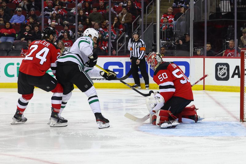 Jan 20, 2024; Newark, New Jersey, USA; New Jersey Devils goaltender Nico Daws (50) makes a save on Dallas Stars left wing Jamie Benn (14) during the third period at Prudential Center. Mandatory Credit: Ed Mulholland-USA TODAY Sports