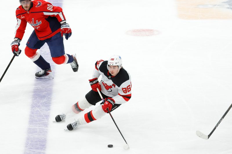 Mar 20, 2026; Washington, District of Columbia, USA; New Jersey Devils center Jack Hughes (86) skates with the puck past Washington Capitals center Pierre-Luc Dubois (80) during the third period at Capital One Arena. Mandatory Credit: Amber Searls-Imagn Images