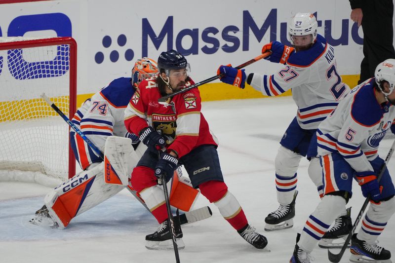 Jun 18, 2024; Sunrise, Florida, USA; Edmonton Oilers defenseman Brett Kulak (27) defends against Florida Panthers forward Ryan Lomberg (94) during the first period in game five of the 2024 Stanley Cup Final at Amerant Bank Arena. Mandatory Credit: Jim Rassol-USA TODAY Sports