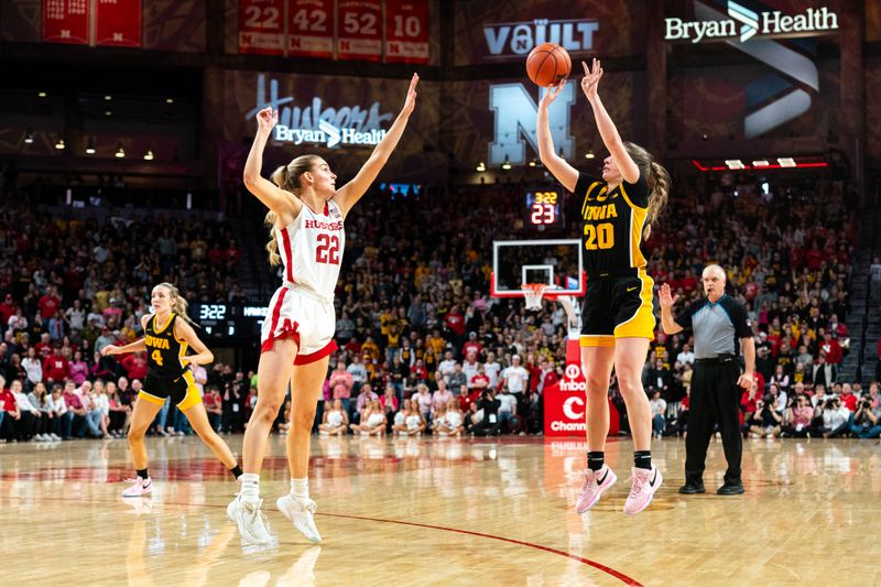 Feb 11, 2024; Lincoln, Nebraska, USA; Iowa Hawkeyes guard Kate Martin (20) shoots a three point shot against Nebraska Cornhuskers forward Natalie Potts (22) during the fourth quarter at Pinnacle Bank Arena. Mandatory Credit: Dylan Widger-USA TODAY Sports