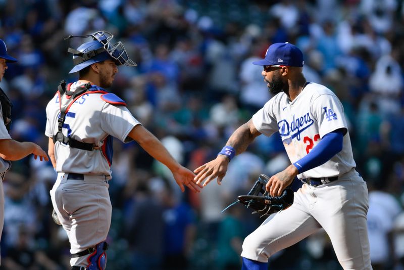 Sep 17, 2023; Seattle, Washington, USA; Los Angeles Dodgers catcher Austin Barnes (15) and right fielder Jason Heyward (23) celebrate defeating the Seattle Mariners at T-Mobile Park. Mandatory Credit: Steven Bisig-USA TODAY Sports