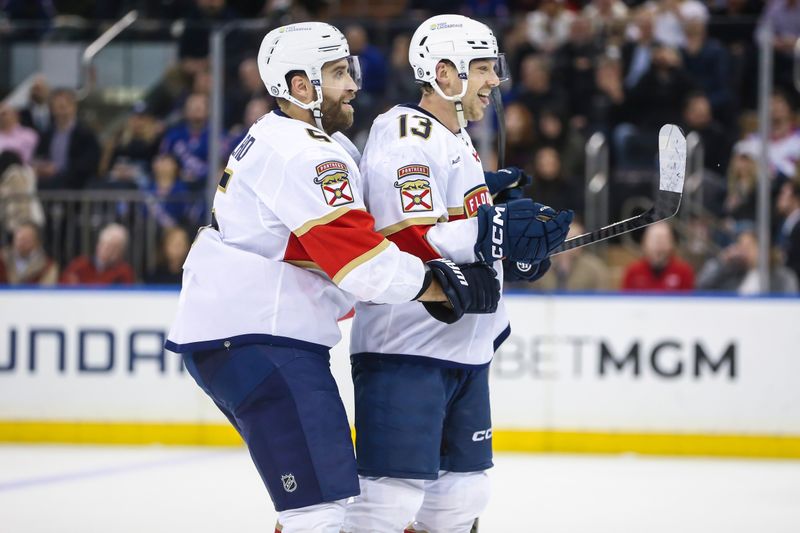 Mar 4, 2024; New York, New York, USA;  Florida Panthers center Sam Reinhart (13) celebrates with defenseman Aaron Ekblad (5) after scoring a goal in the second period against the New York Rangers at Madison Square Garden. Mandatory Credit: Wendell Cruz-USA TODAY Sports