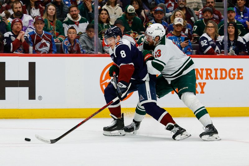 Feb 26, 2026; Denver, Colorado, USA; Colorado Avalanche defenseman Cale Makar (8) and Minnesota Wild center Yakov Trenin (13) battle for the puck in the first period at Ball Arena. Mandatory Credit: Isaiah J. Downing-Imagn Images