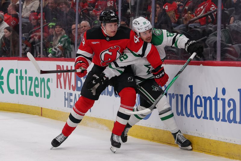 Dec 3, 2025; Newark, New Jersey, USA; Dallas Stars center Mavrik Bourque (22) and New Jersey Devils defenseman Dennis Cholowski (44) battle along the boards during the first period at Prudential Center. Mandatory Credit: Ed Mulholland-Imagn Images