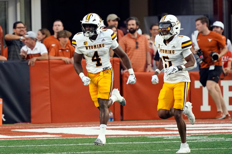 Sep 16, 2023; Austin, Texas, USA; Wyoming Cowboys running back Harrison Waylee (4) reacts after scoring a touchdown in the first half against the Texas Longhorns at Darrell K Royal-Texas Memorial Stadium. Mandatory Credit: Scott Wachter-USA TODAY Sports