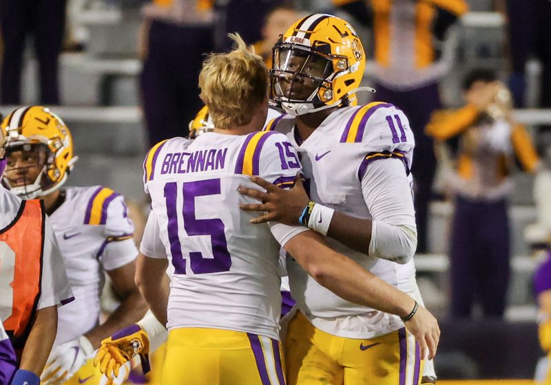 Oct 24, 2020; Baton Rouge, Louisiana, USA; LSU Tigers quarterback TJ Finley (11) celebrates with quarterback Myles Brennan (15) after a touchdown against the South Carolina Gamecocks during the first half at Tiger Stadium. Mandatory Credit: Derick E. Hingle-USA TODAY Sports