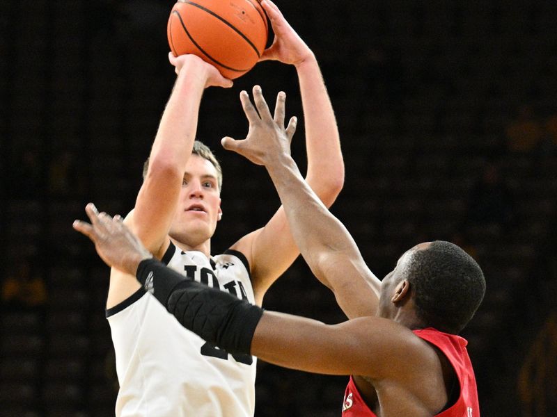 Jan 6, 2024; Iowa City, Iowa, USA; Iowa Hawkeyes forward Payton Sandfort (20) shoots a three point basket over Rutgers Scarlet Knights forward Aundre Hyatt (5) during the second half at Carver-Hawkeye Arena. Mandatory Credit: Jeffrey Becker-USA TODAY Sports